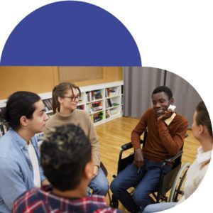 Black young man in wheelchair in a circle with a group