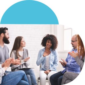 Young black woman surrounded by support group