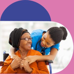 Photo of a nurse cuddling a patient in her care who is sitting in front of her