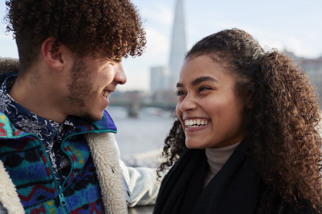A photo of young couple smiling.
