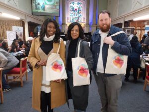 two women and a man with should tote bags at the Lambeth Together community health day for black communities