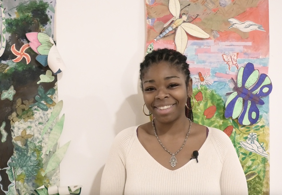 Shakyrah from Elevate smiling against a colourful nature mural