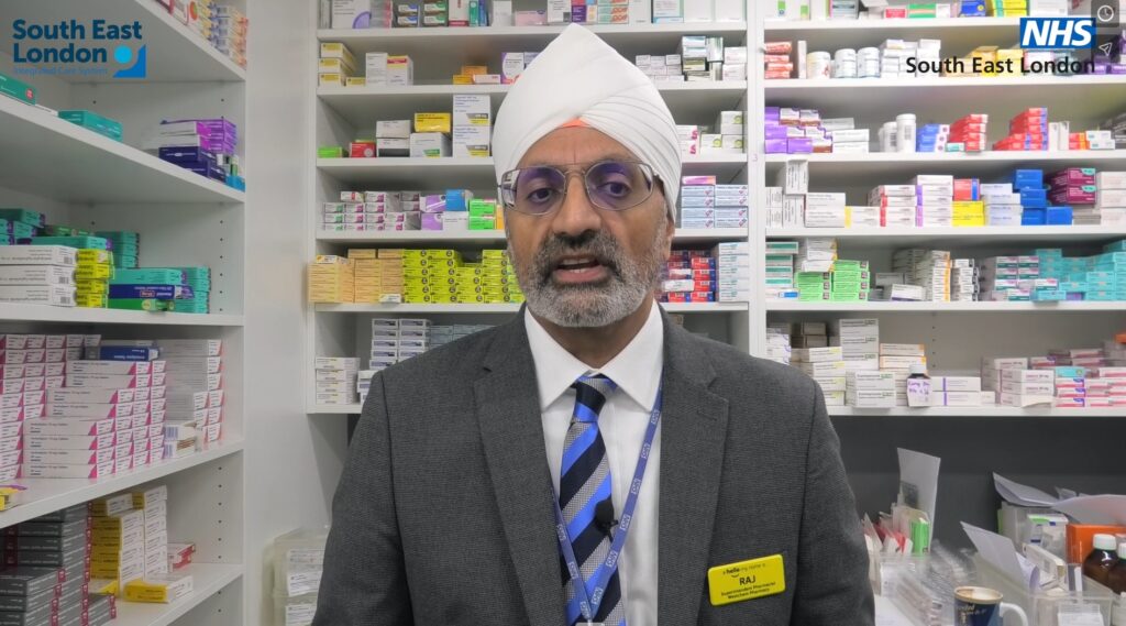 Raj Matharu, Chair Community Pharmacy London with shelves of medicine behind