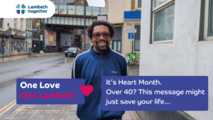 A smiling man in a blue jacket stands on a city street. Text reads: One Love, One Lambeth. It’s Heart Month. Over 40? This message might just save your life... Lambeth Together logo is in the corner.